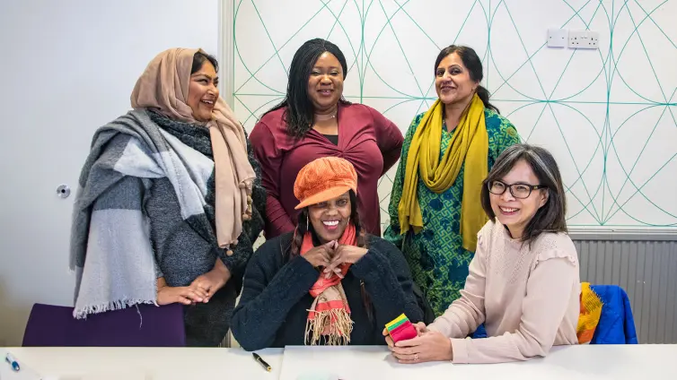 Picture of 5 people smiling and laughing.
