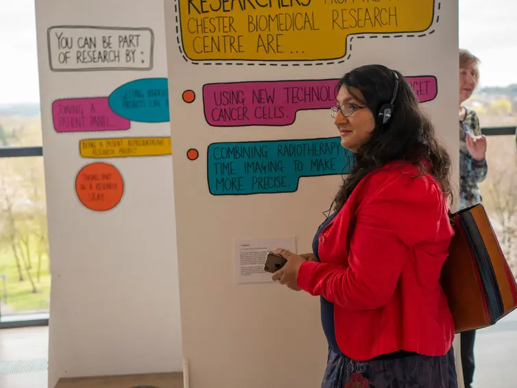 A woman listening to audio files as part of an art exhibition.