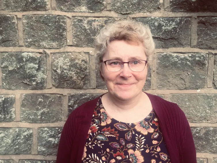 Photo of Sharon smiling.