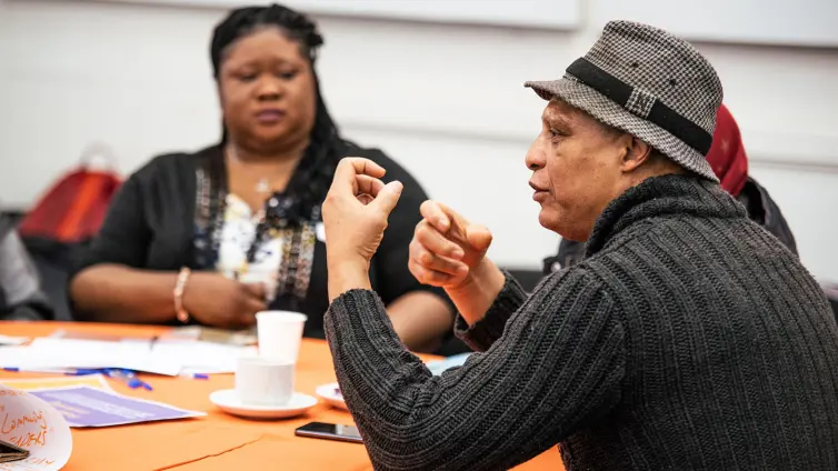 People sat on a table talking.